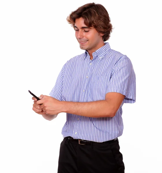 Smiling young man sending a message by cellphone — Stock Photo, Image