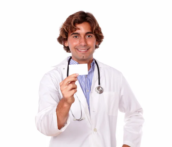 Smiling male doctor holding a business card. — Stock Photo, Image