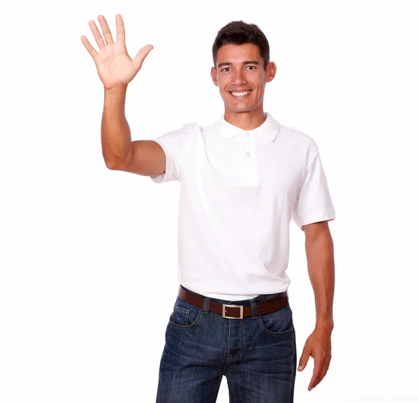 Smiling young man with a greeting hand gesture — Stock Photo, Image
