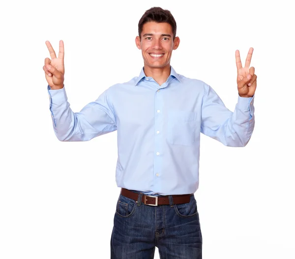 Jovem latino está sorrindo com um sinal de vitória . — Fotografia de Stock