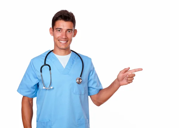 Male nurse pointing to his left — Stock Photo, Image