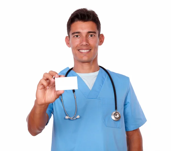 Charming male nurse holding a blank business card — Stock Photo, Image