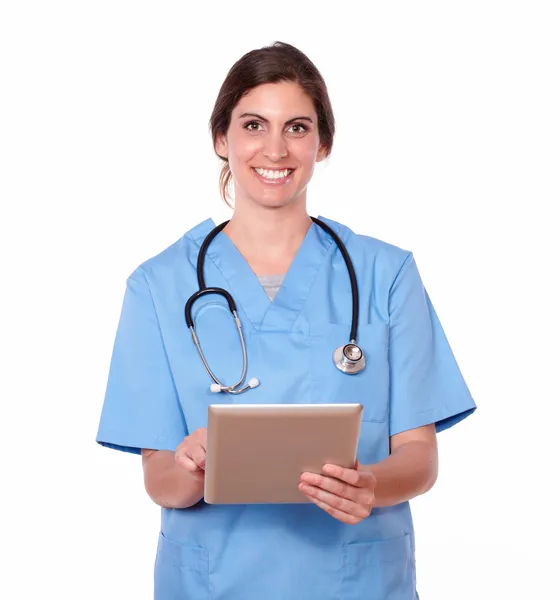 Smiling pretty lady nurse working on tablet pc — Stock Photo, Image