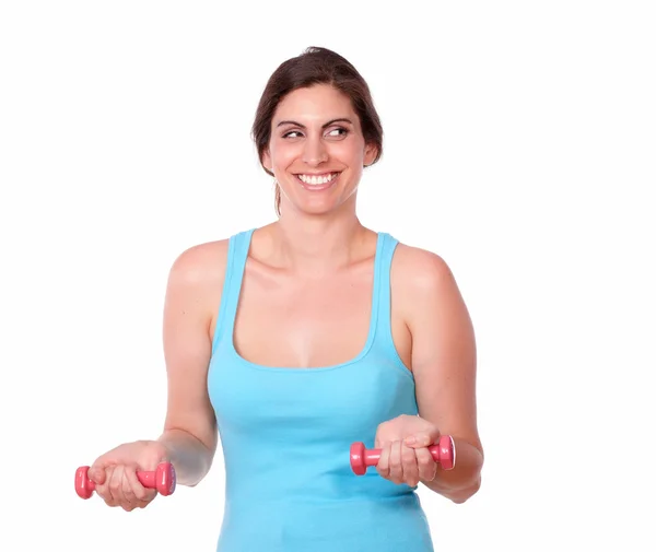 Sporty female in gym clothing lifting weights — Stock Photo, Image