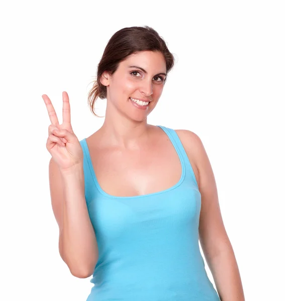 Young woman in gym clothing gesturing victory sign — Stock Photo, Image