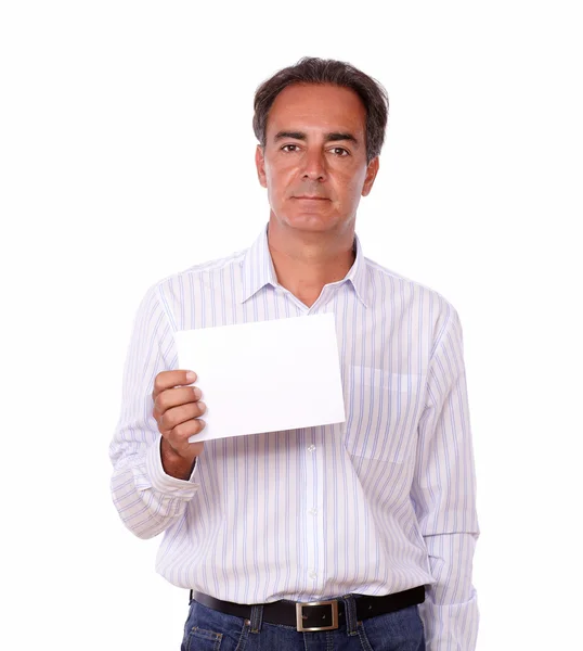 Hispanic male standing and holding a card — Stock Photo, Image