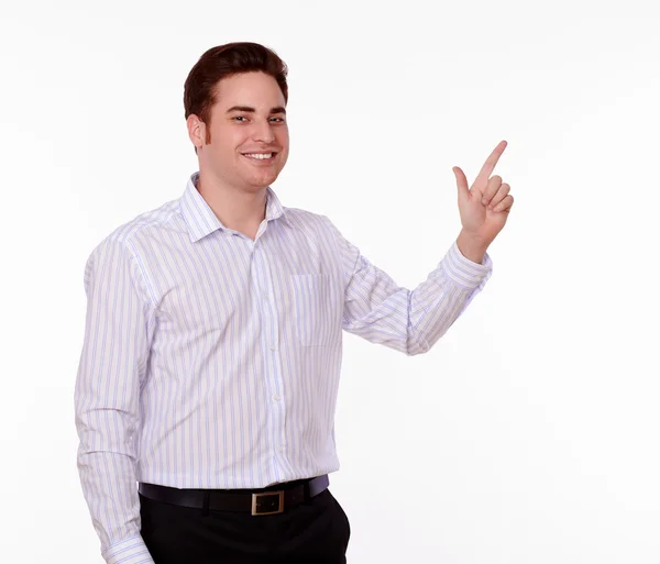 Attractive young man pointing while smiling — Stock Photo, Image