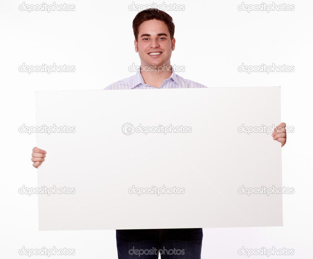 Download - Portrait of an attractive young man holding up a blank placard w...