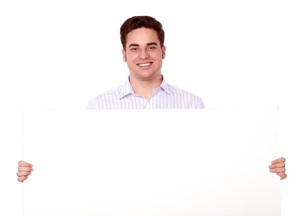 Charming young man holding a blank placard — Stock Photo, Image