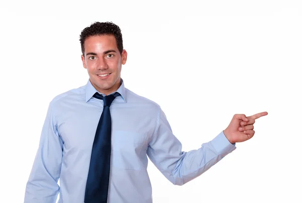 Handsome young man pointing to his left — Stock Photo, Image