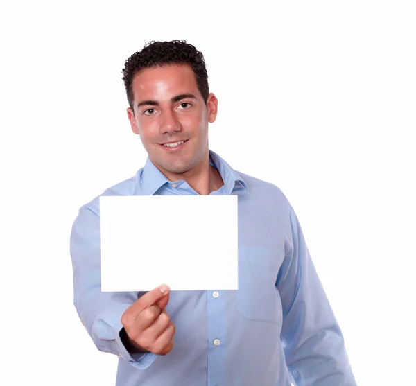 Attractive hispanic guy holding a white card — Stock Photo, Image