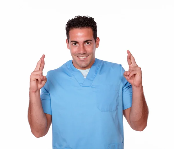 Gorgeous male nurse crossing his fingers — Stock Photo, Image