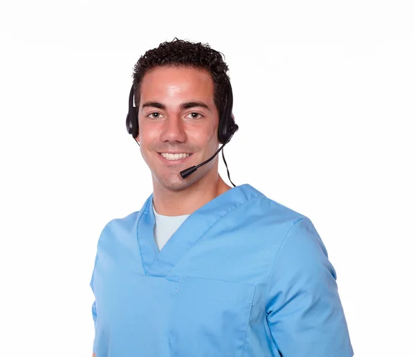 Atractiva enfermera masculina con auriculares sonriendo —  Fotos de Stock