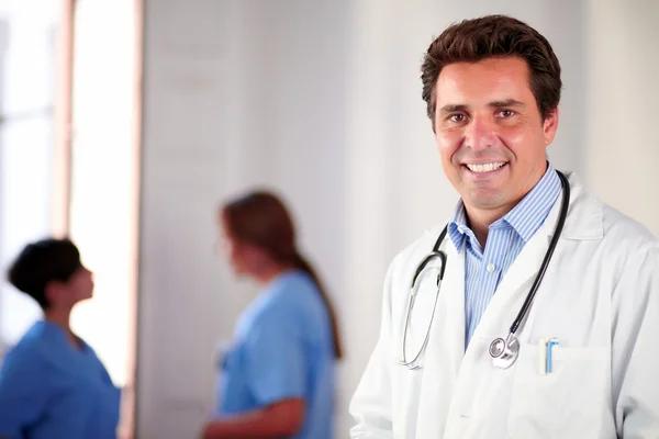 Adult hispanic doctor on white coat standing — Stock Photo, Image