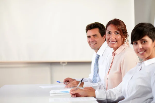 Adult executive group smiling at you — Stock Photo, Image