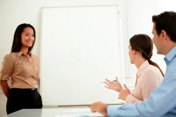 Young businesswoman smiling at professional team — Stock Photo, Image