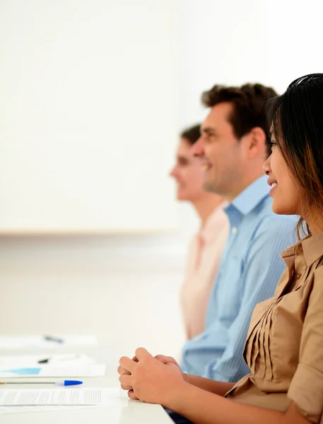 Team of coworkers listen during a conference — Stock Photo, Image