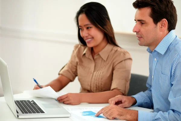 Male and female colleagues working on documents — Stock Photo, Image