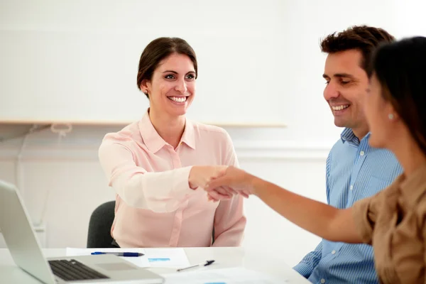 Beautiful female coworkers giving greeting gesture — Stock Photo, Image