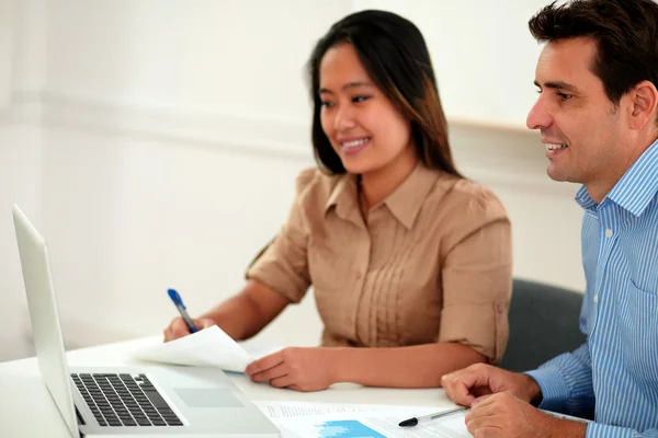 Two multi ethnic colleagues working on documents — Stock Photo, Image