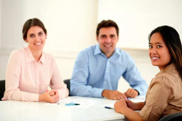 Charming adult colleagues smiling at you — Stock Photo, Image