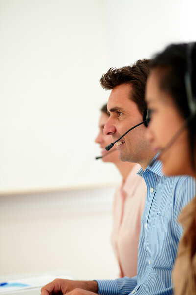 Man and women operator working with headphones