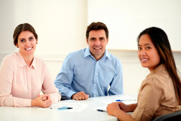 Attractive executive ethnic group smiling at you — Stock Photo, Image