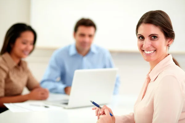 Beautiful businesswoman looking and smiling at you Stock Photo