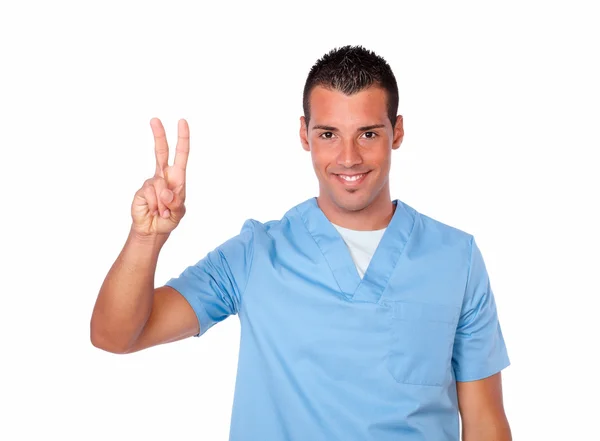 Excited male nurse smiling with victory sign — Stock Photo, Image