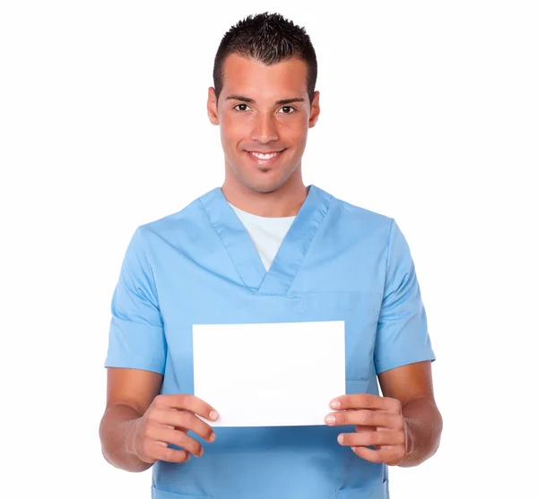 Handsome nurse guy holding a white card — Stock Photo, Image