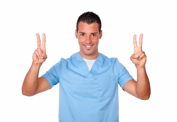 Człowiek szczęśliwy pielęgniarki uśmiechając się z wygranej znak — Zdjęcie stockowe