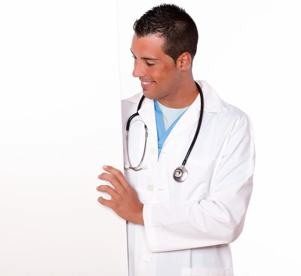 Attractive male doctor holding a white placard — Stock Photo, Image