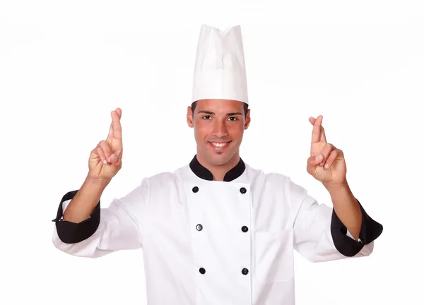 Pohledný mladý kuchař přes prsty — Stock fotografie