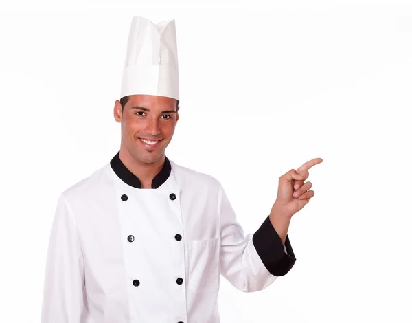 Chef profesional adulto apuntando a su izquierda — Foto de Stock