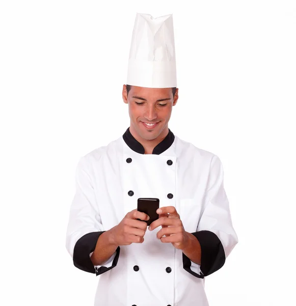 Professional young chef texting a message — Stock Photo, Image