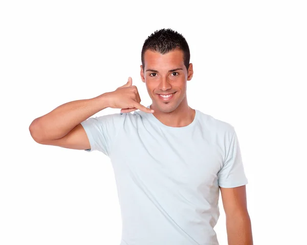 Latin guy standing with calling gesture — Stock Photo, Image