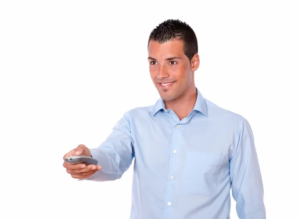 Hispanic man pointing with remote control — Stock Photo, Image