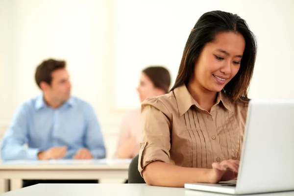 Adult asiatic woman working on her laptop — Stock Photo, Image