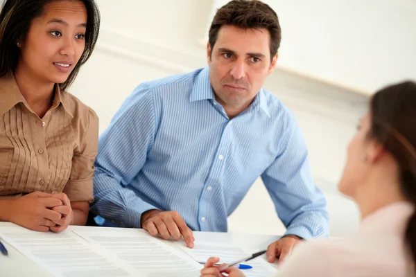 Ethnic couple interested in a contract — Stock Photo, Image