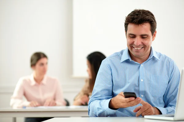 Charming hispanic male reading a message — Stock Photo, Image