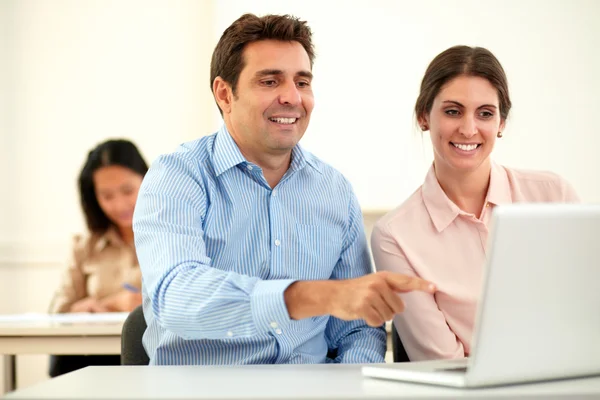 Professional couple working on laptop and smiling — Stock Photo, Image