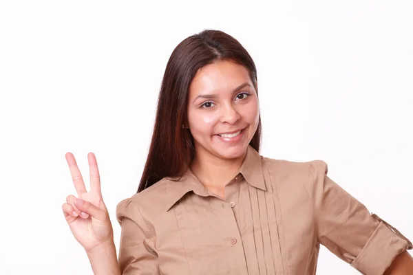 Glada spansktalande dam med seger tecken — Stockfoto