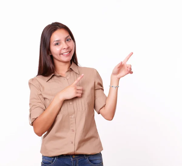 Cute hispanic female pointing to her left — Stock Photo, Image