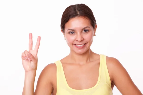 Cheerful young lady with winning sign — Stock Photo, Image