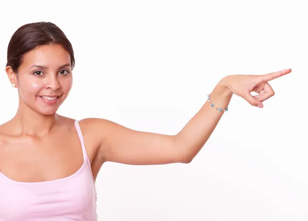 Brunette pointing and looking to her left — Stock Photo, Image