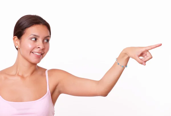 Brunette pointing and looking to her left — Stock Photo, Image