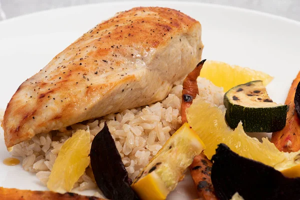 Grilled chicken breast with rice and grilled vegetables for Colombian lunch