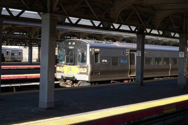 Queens, NY; Circa 2022: Busy Long Island Railroad commuter train terminal at Jamaica Station LIRR platform passing through junction