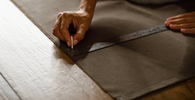 fabric marking hands ruler seamstress. High quality photo