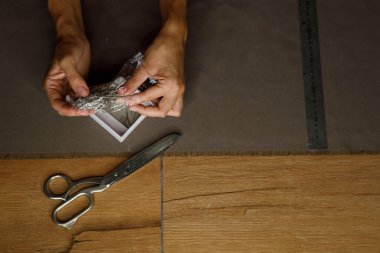 fabric marking hands ruler seamstress. High quality photo